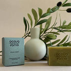 Acqua Forno soap and packaging with a vase and greenery on a neutral background